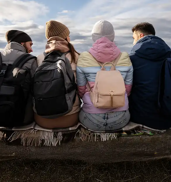 A group of teens sitting together in the form of a group showing a mutual bond of friendship and trust.