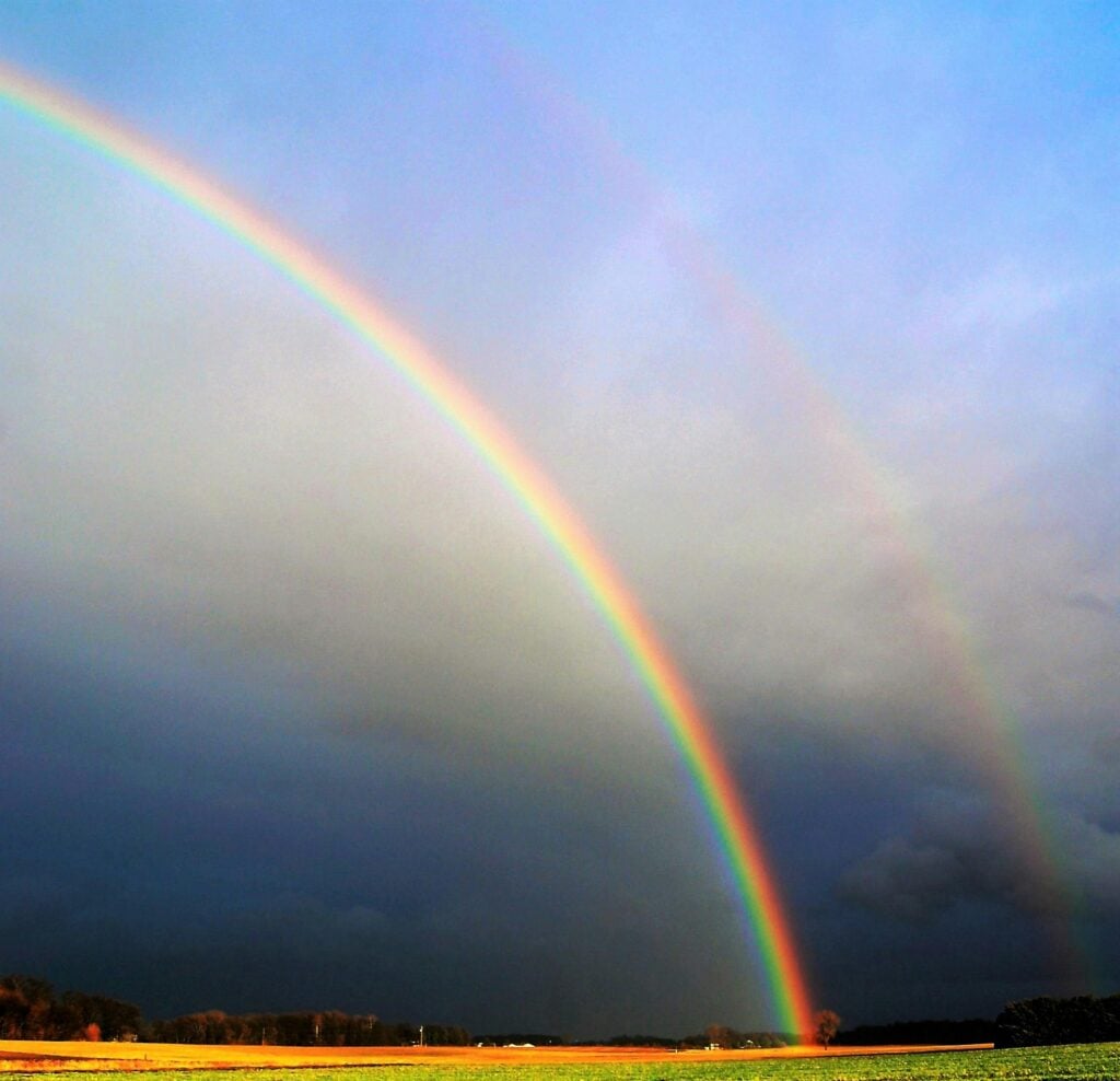 Double rainbow stretching over the Colorado landscape, symbolizing hope, healing, and the renewed sense of safety found through the Seeking Safety Trauma and PTSD Support Groups.