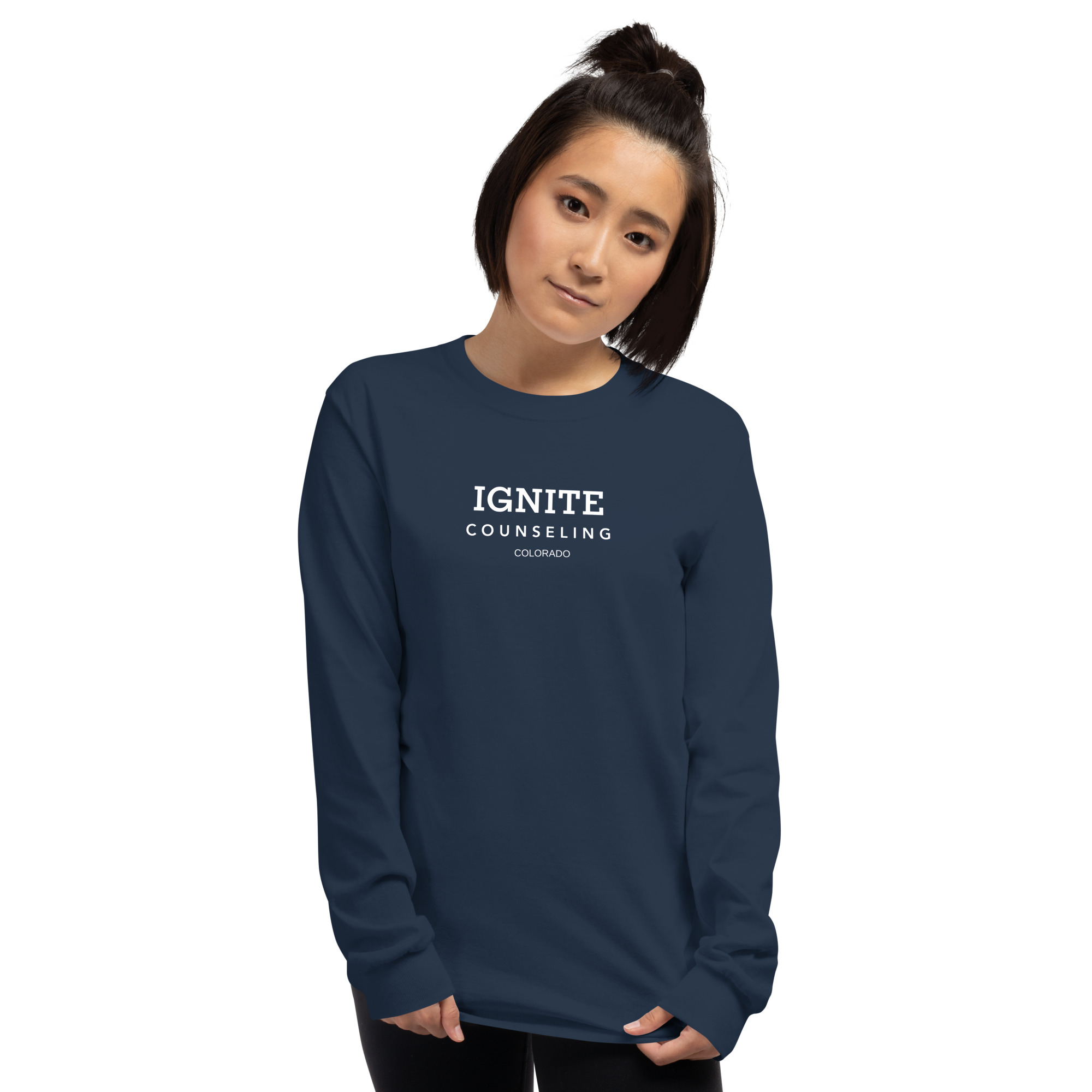 Woman modeling a navy blue long-sleeve t-shirt featuring the Ignite Counseling Colorado logo.