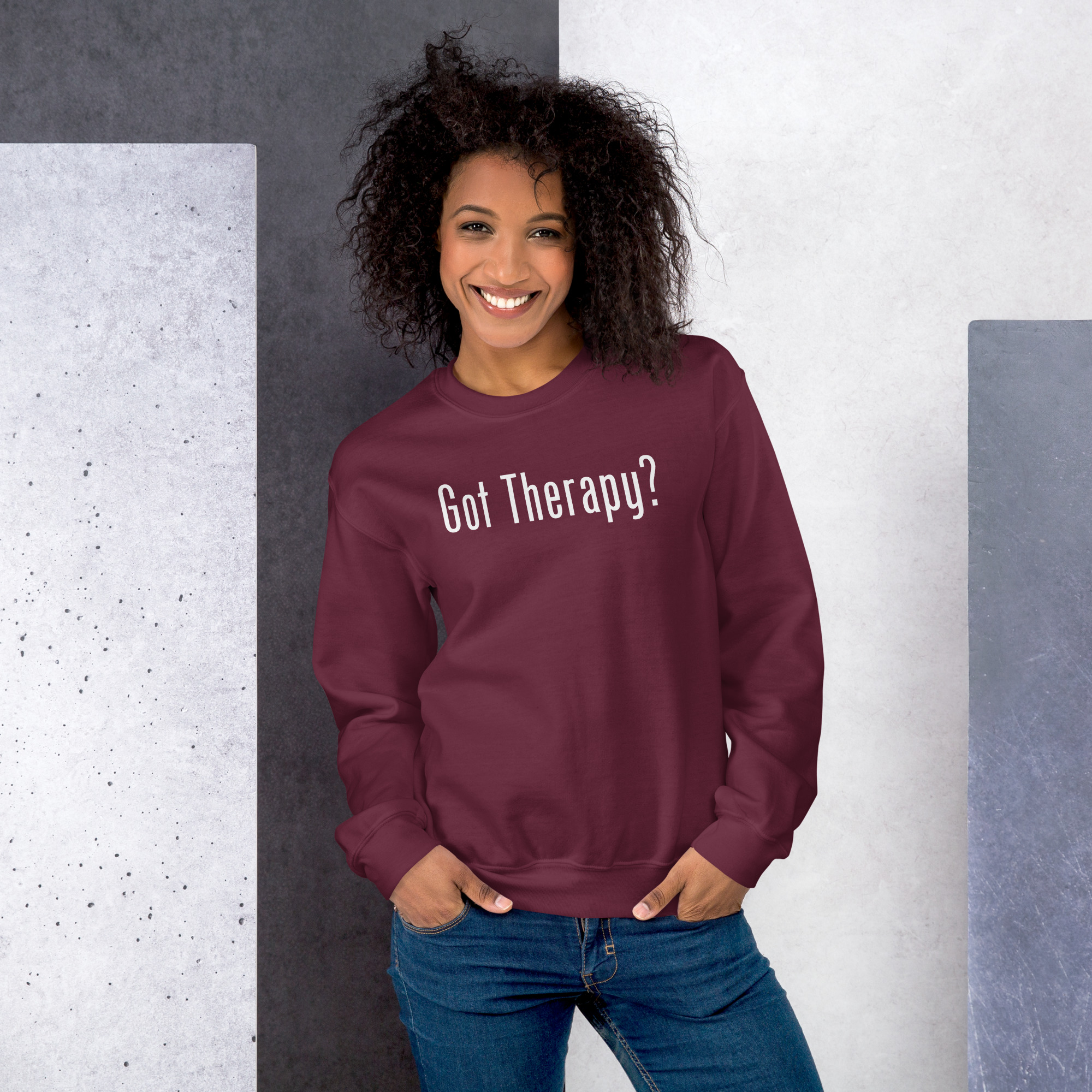 Smiling woman modeling a maroon sweatshirt featuring the text 'Got Therapy?'.
