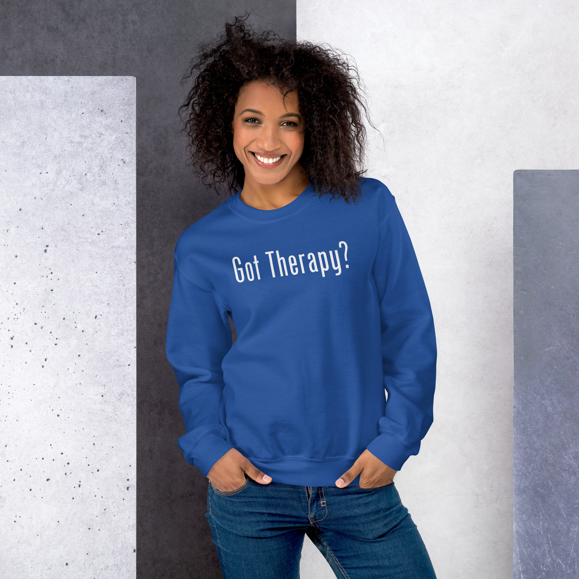 Smiling woman modeling a royal blue sweatshirt featuring the text 'Got Therapy?'.