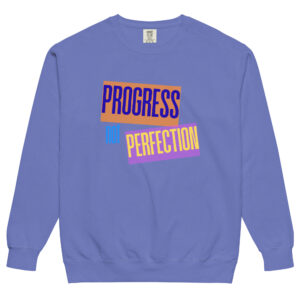 Front view of a light purple sweatshirt featuring the empowering quote 'Progress not Perfection' in colorful graphic blocks.