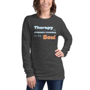 Smiling woman modeling a heather dark grey long-sleeve t-shirt featuring the empowering quote 'Therapy is Strength Training for the Soul.