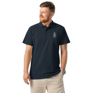 Smiling man modeling a navy blue polo shirt featuring the Ignite Counseling logo.