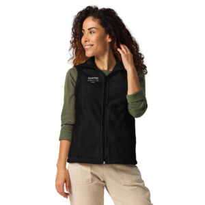 Smiling woman modeling a black fleece vest featuring the Ignite Counseling Colorado logo.
