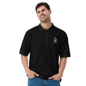 Smiling man modeling a black polo shirt featuring the Ignite Counseling Colorado logo.