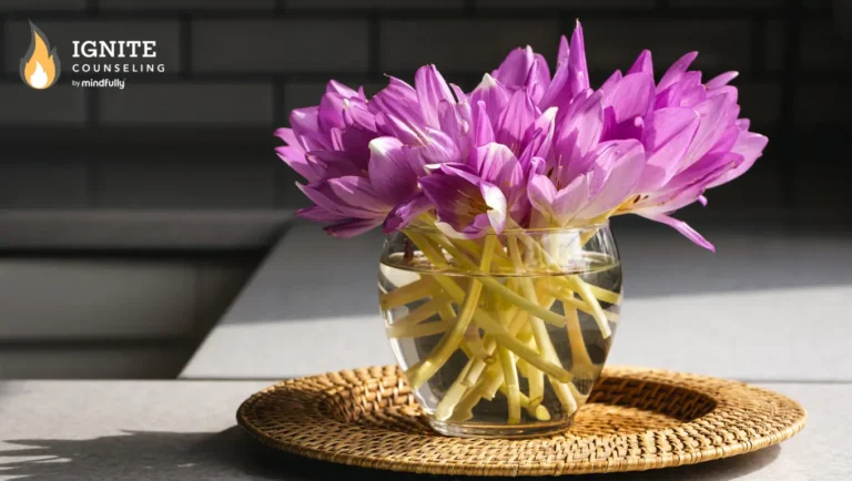 Glass vase filled with bright purple flowers sitting in the sunlight, symbolizing hope and renewal.