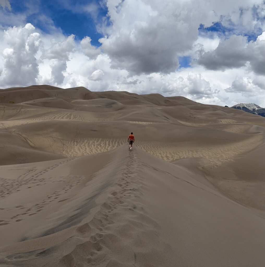 Lonely man walking in the Colorado Great Sand Dunes National Park